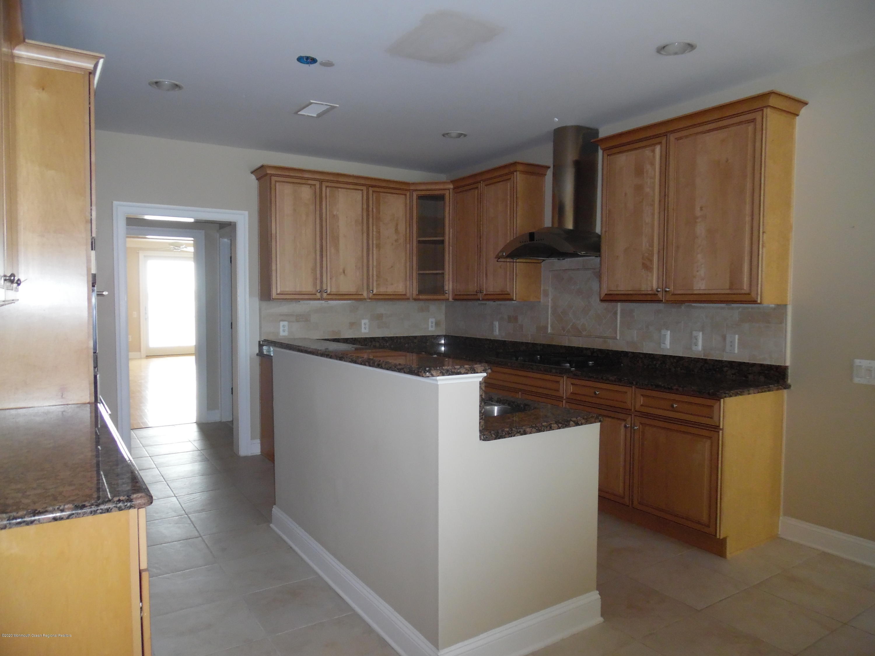 2201 River Road, Unit 2203 Point Pleasant, NJ 08742 - Photo 23 of 23 a kitchen with stainless steel appliances granite countertop a sink and a stove