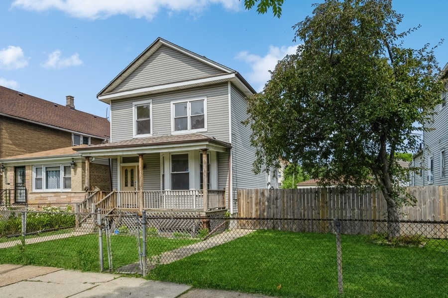 2139 North Kenneth Avenue Chicago, IL 60639 - Photo 1 of 21 a front view of a house with a yard and green space