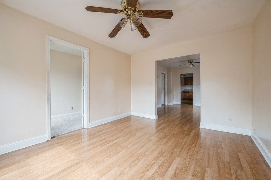 2139 North Kenneth Avenue Chicago, IL 60639 - Photo 13 of 21 wooden floor in an empty room with a window