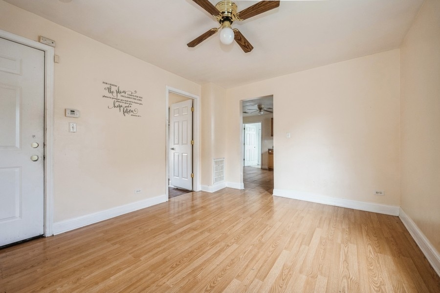 2139 North Kenneth Avenue Chicago, IL 60639 - Photo 16 of 21 an empty room with wooden floor and windows