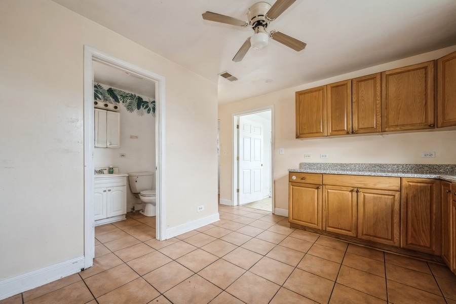 2139 North Kenneth Avenue Chicago, IL 60639 - Photo 17 of 21 a kitchen with a refrigerator a sink and cabinets