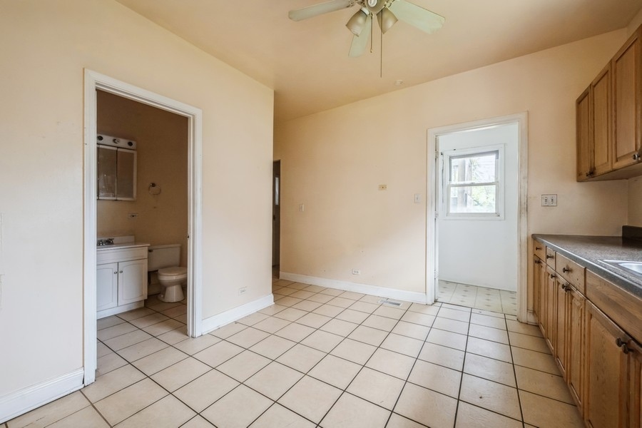 2139 North Kenneth Avenue Chicago, IL 60639 - Photo 6 of 21 a view of a kitchen with wooden floor and a sink