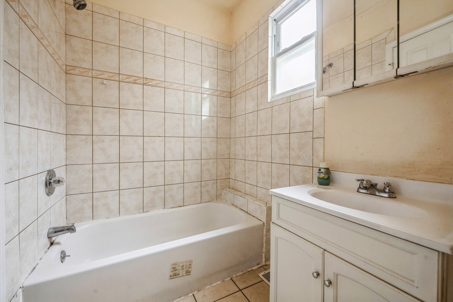 2139 North Kenneth Avenue Chicago, IL 60639 - Photo 9 of 21 a bathroom with a bathtub
