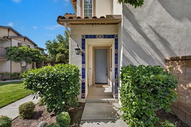 a front view of a house with plants