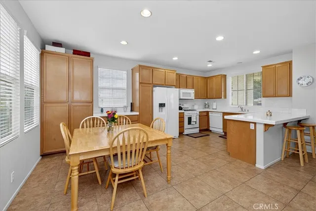 a view of kitchen with granite countertop furniture and a dining table