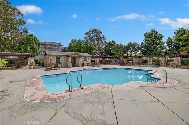 a view of house with swimming pool outdoor seating