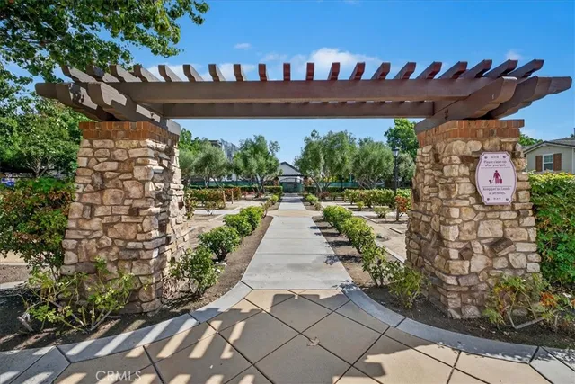 a view of a pathway with a wrought fence