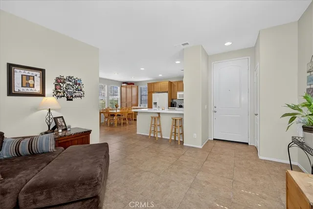 a living room with furniture and kitchen view