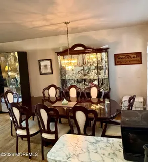 a view of a dining room with furniture and chandelier