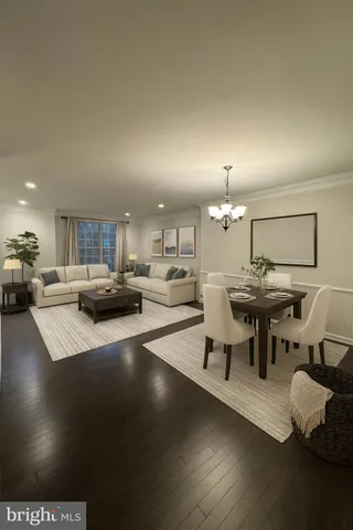 a living room with lots of furniture and view of kitchen