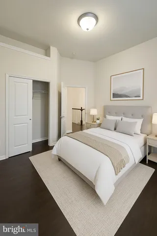 a bedroom with a bed and a painting on the wall