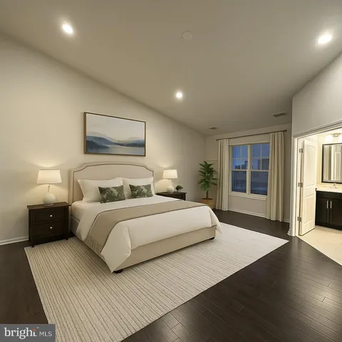 a bedroom with a large bed and wooden floor