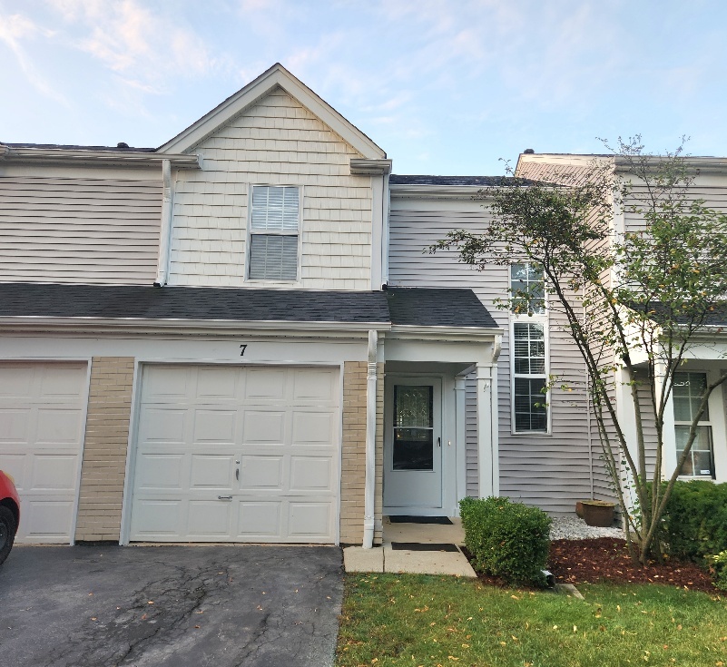 7 Marion Lane Streamwood, IL 60107 - Photo 1 of 10 a view of a house with a small yard and a large tree