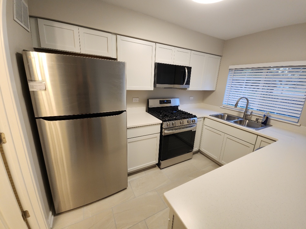 7 Marion Lane Streamwood, IL 60107 - Photo 2 of 10 a kitchen with stainless steel appliances a refrigerator stove and microwave