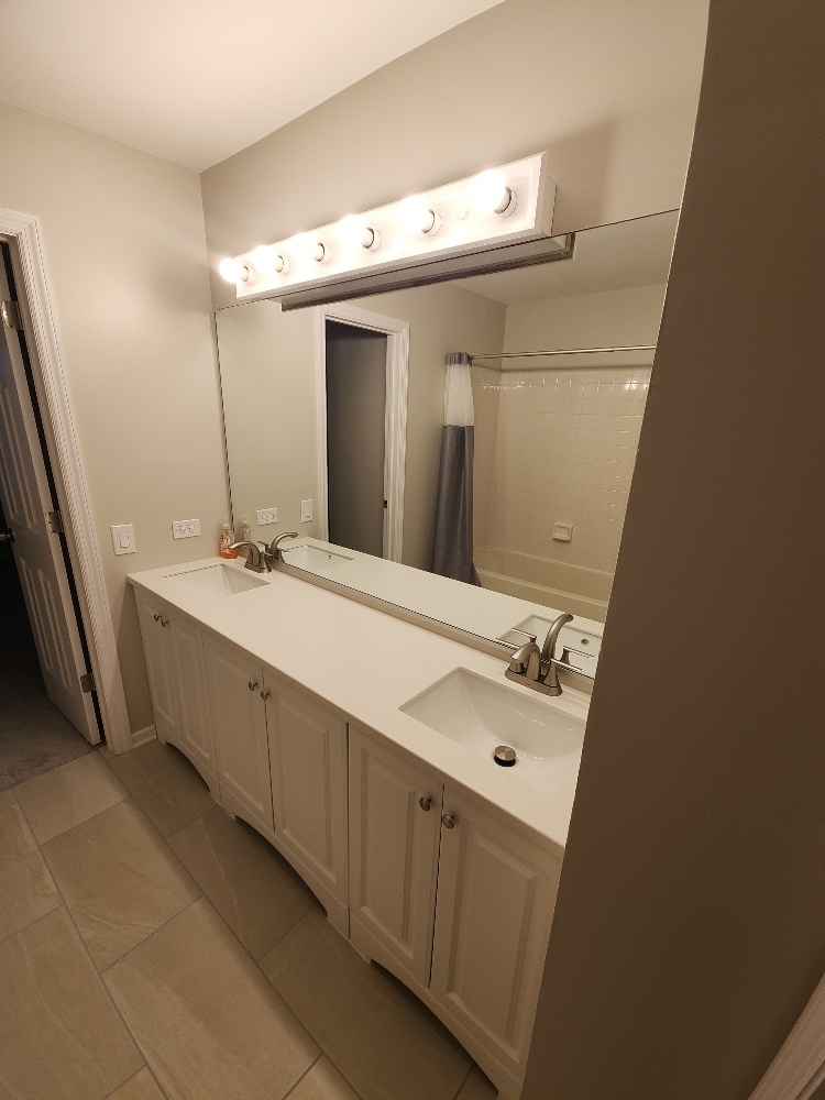 7 Marion Lane Streamwood, IL 60107 - Photo 4 of 10 a bathroom with a double vanity sink and mirror