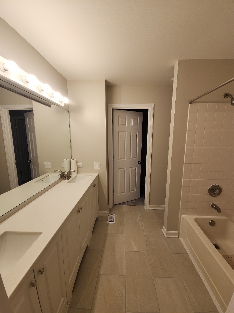 7 Marion Lane Streamwood, IL 60107 - Photo 5 of 10 a spacious bathroom with a tub sink shower and mirror