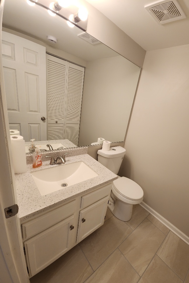 7 Marion Lane Streamwood, IL 60107 - Photo 6 of 10 a bathroom with a sink a toilet and a mirror