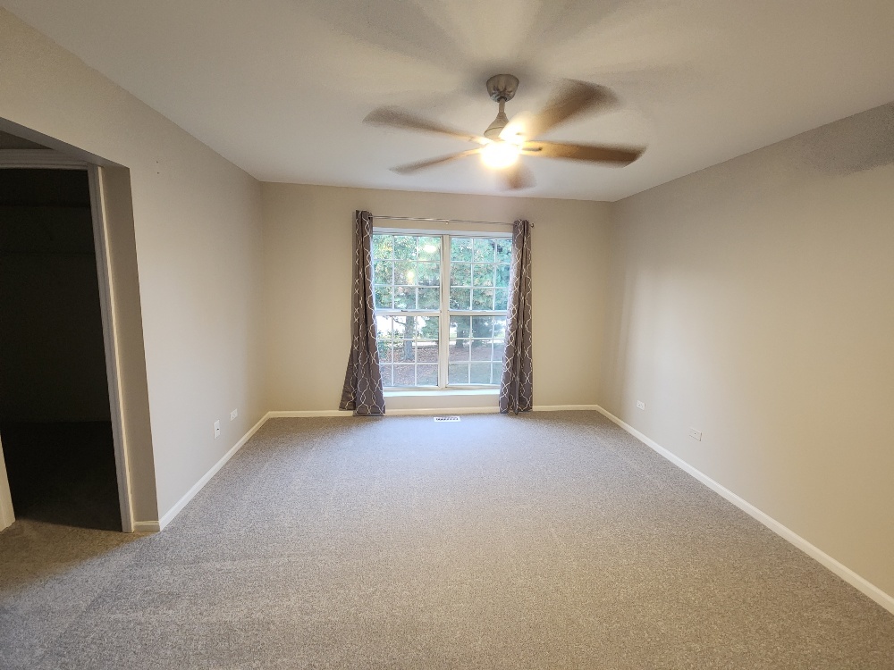 7 Marion Lane Streamwood, IL 60107 - Photo 9 of 10 an empty room with windows and fan