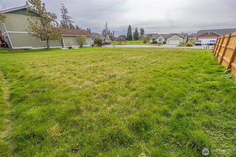 a view of an house with backyard space and balcony