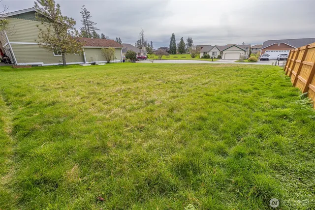a view of an house with backyard space and balcony