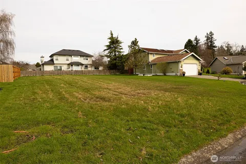 a view of a house next to a big yard