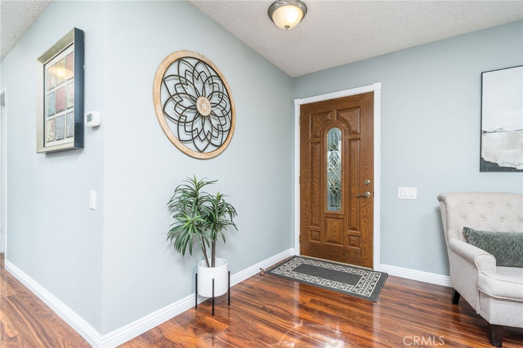 9121 Helms Avenue Rancho Cucamonga, CA 91730 - Photo 6 of 43 a view of a hallway with entryway wooden floor and front door