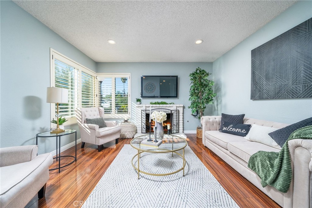 9121 Helms Avenue Rancho Cucamonga, CA 91730 - Photo 7 of 43 a living room with fireplace furniture and a large window