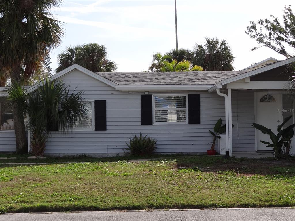 13360 Boca Ciega Avenue Madeira Beach, FL 33708 - Photo 33 of 45 a front view of a house with a garden