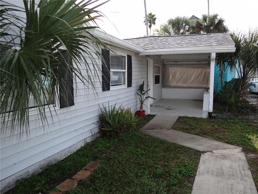 13360 Boca Ciega Avenue Madeira Beach, FL 33708 - Photo 38 of 45 a front view of a house with garden