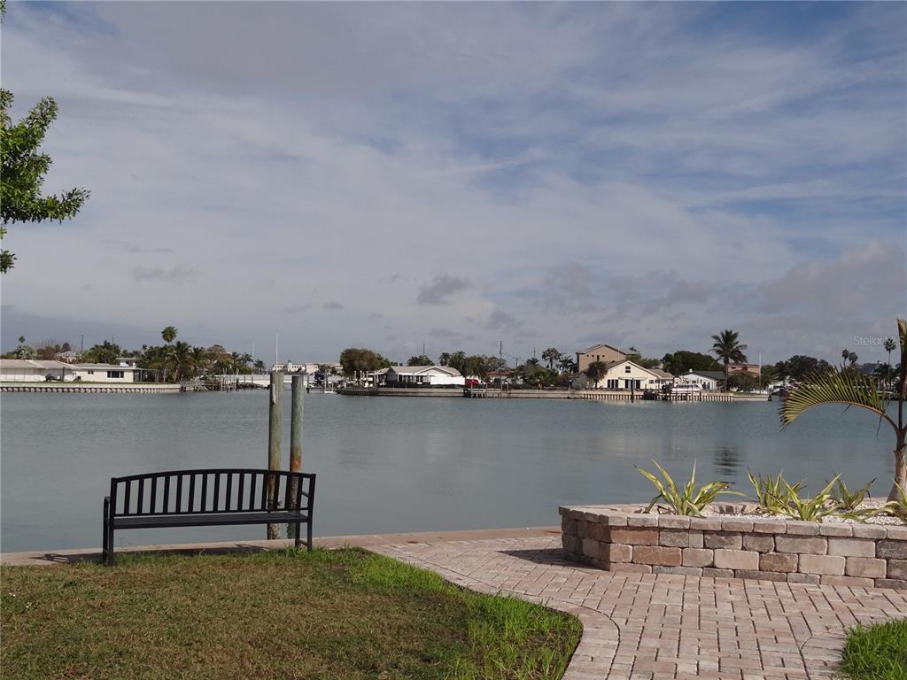 13360 Boca Ciega Avenue Madeira Beach, FL 33708 - Photo 4 of 45 a terrace with a bench and lake view