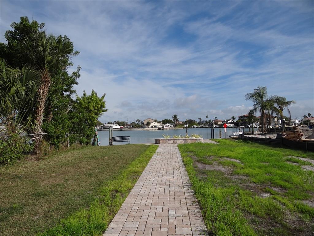 13360 Boca Ciega Avenue Madeira Beach, FL 33708 - Photo 42 of 45 a view of a lake with a garden