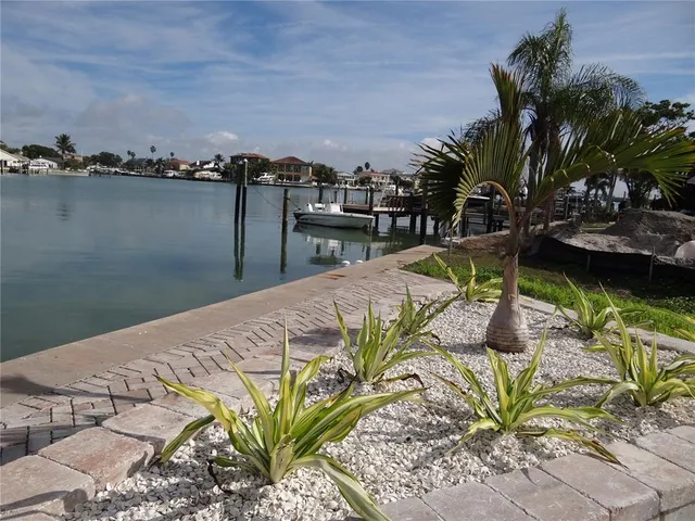 a view of a lake with a table and chairs