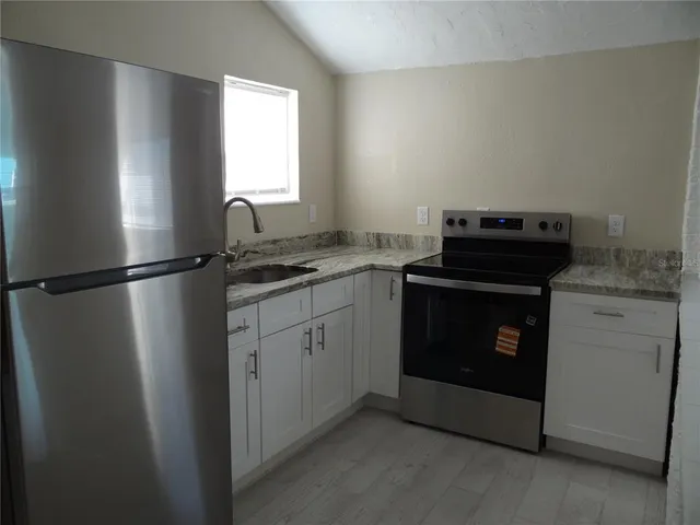 a kitchen with a stove and a refrigerator
