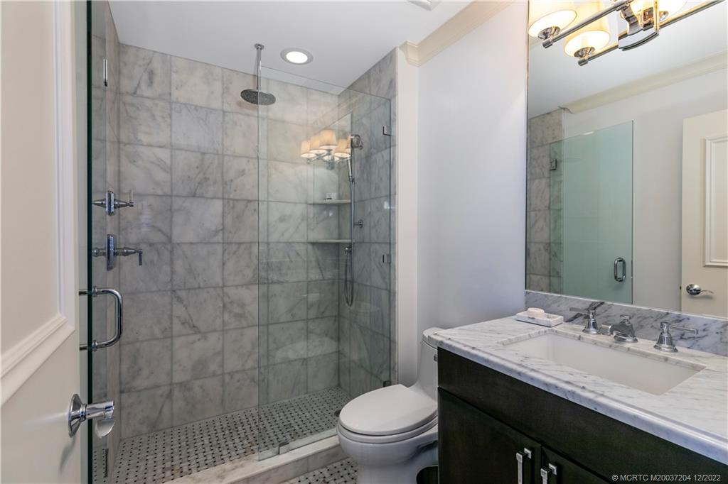 484 Northeast Plantation Road, Unit 4108 Stuart, FL 34996 - Photo 18 of 25 a bathroom with a sink a toilet and shower