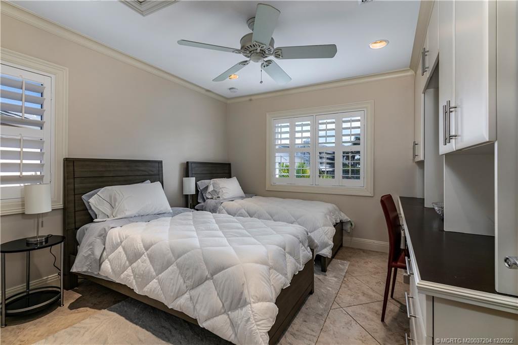 484 Northeast Plantation Road, Unit 4108 Stuart, FL 34996 - Photo 19 of 25 a bedroom with bed and window