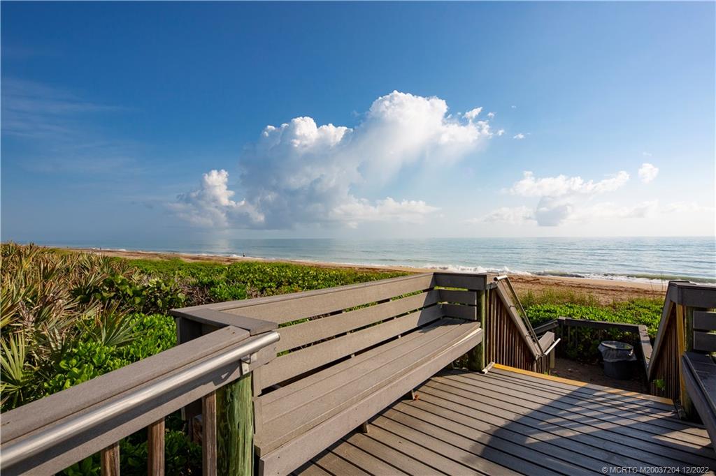484 Northeast Plantation Road, Unit 4108 Stuart, FL 34996 - Photo 2 of 25 a view of a balcony with wooden floor and outdoor seating