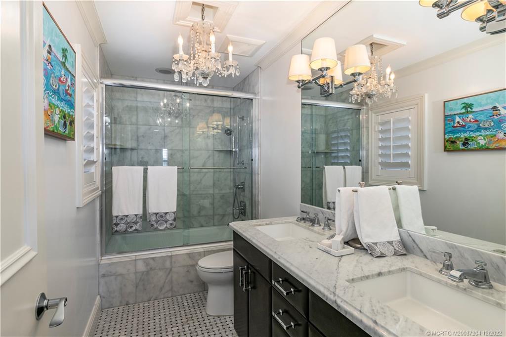 484 Northeast Plantation Road, Unit 4108 Stuart, FL 34996 - Photo 21 of 25 a bathroom with a sink a toilet and shower