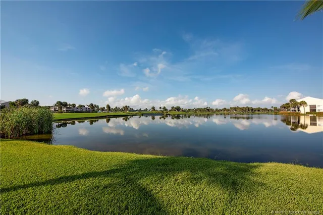 a kitchen with stainless steel appliances granite countertop a sink a stove and refrigerator