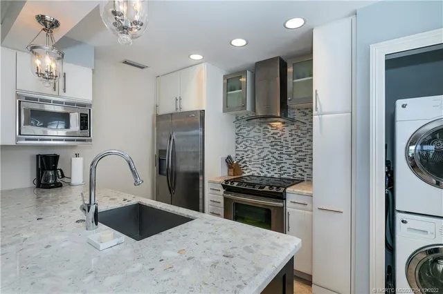 a spacious bathroom with a granite countertop sink a mirror and shower