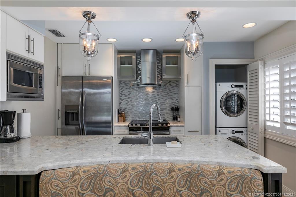 484 Northeast Plantation Road, Unit 4108 Stuart, FL 34996 - Photo 9 of 25 a spacious bathroom with a granite countertop sink a mirror and shower