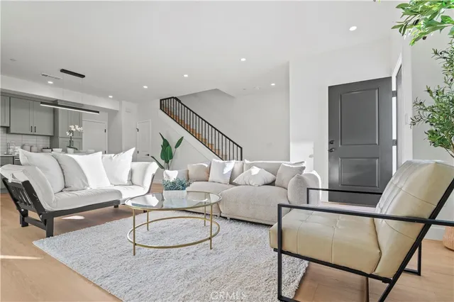 a living room with furniture and a potted plant