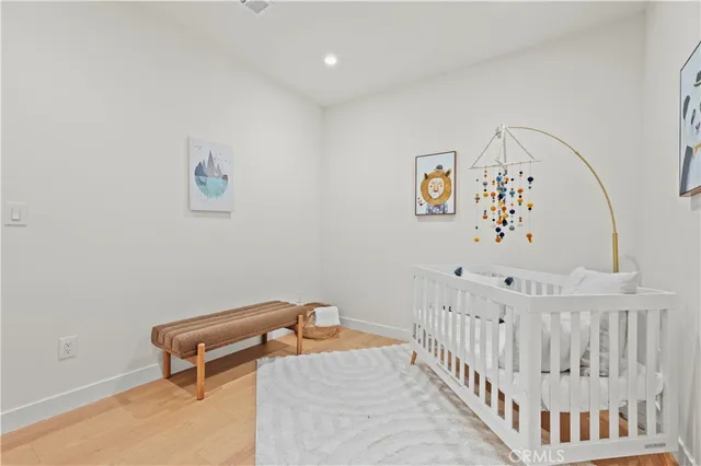a bedroom with furniture and wooden floor