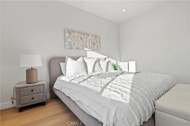 a bedroom with a bed and a painting on the wall