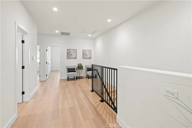 a view of a livingroom with wooden floor and a potted plant
