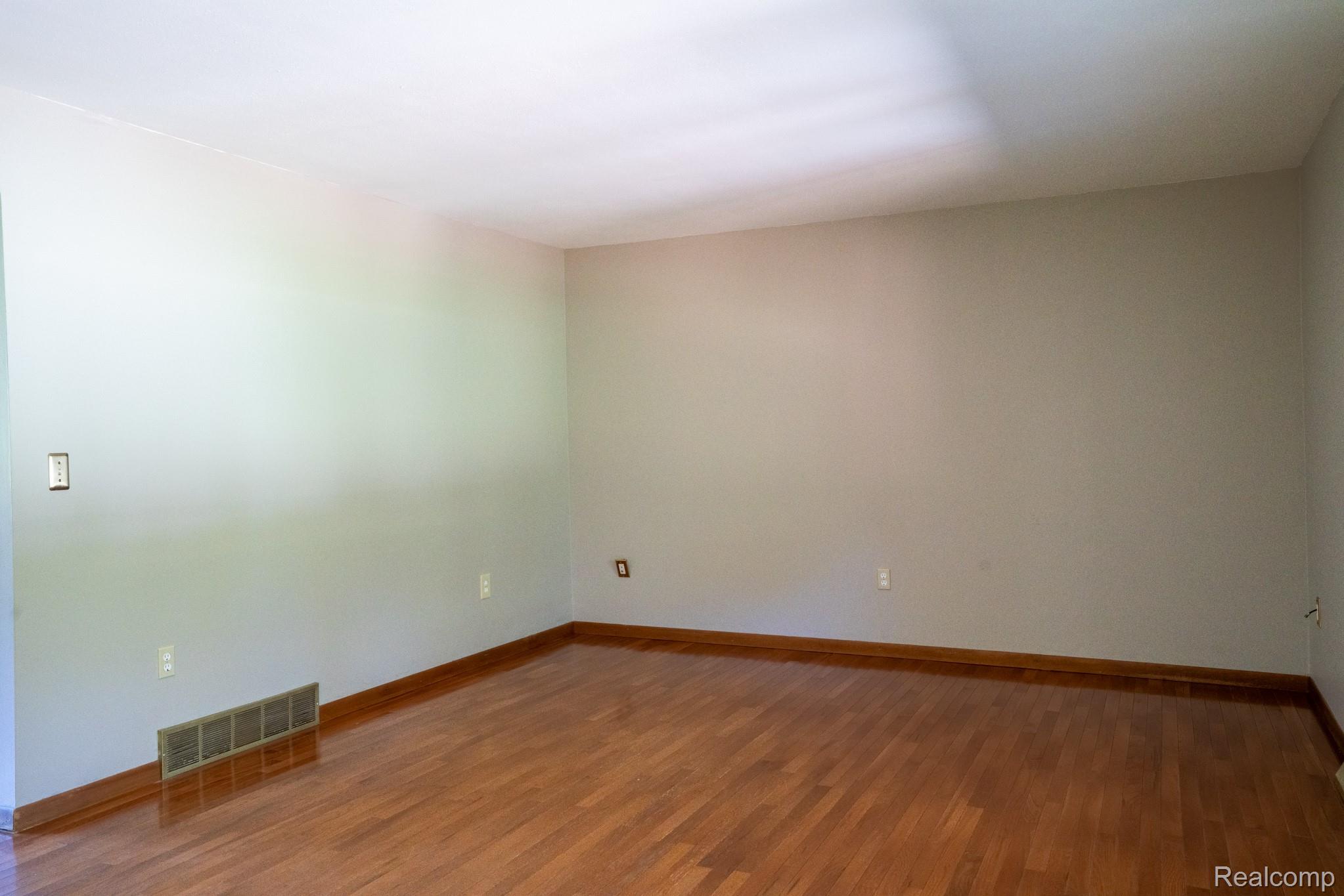 12900 Maxwell Road Carleton, MI 48117 - Photo 26 of 59 Hardwood flooring with wood trim and light-toned walls