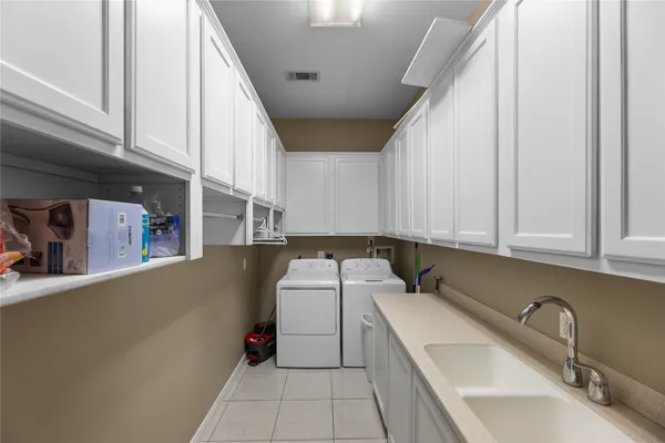 a utility room with sink dryer and washer