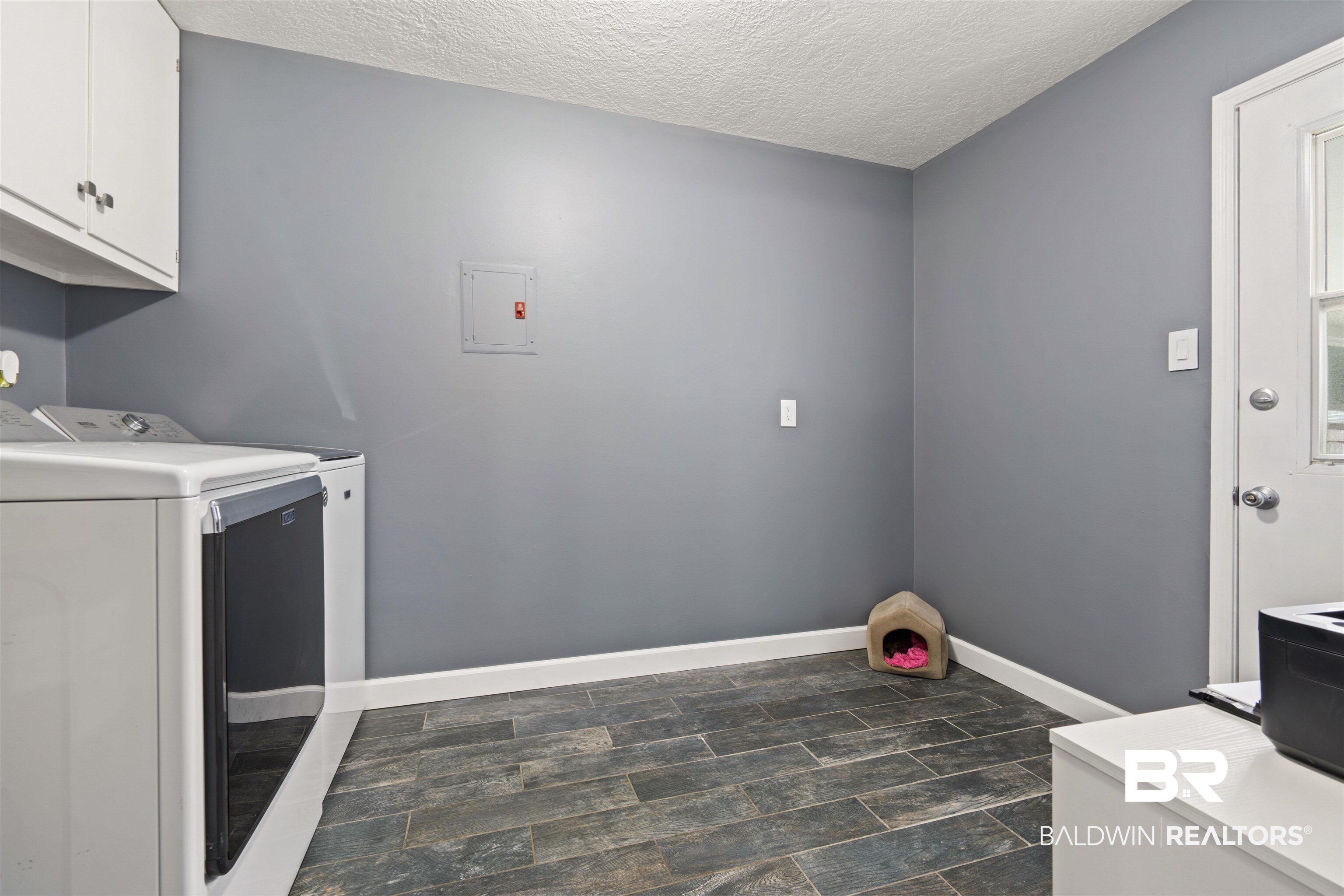 2000 Campfire Drive Semmes, AL 36575 - Photo 20 of 26 Clothes washing area featuring electric panel, washer and clothes dryer, cabinets, and a textured ceiling