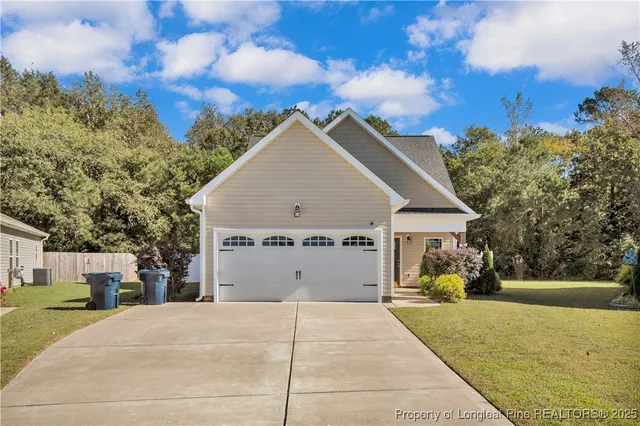 a view of house with yard in front of it