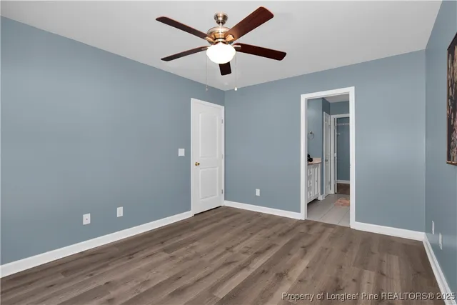 an empty room and closet area with wooden floor