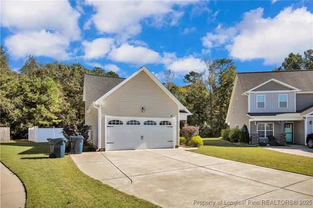 a front view of a house with a yard and trees